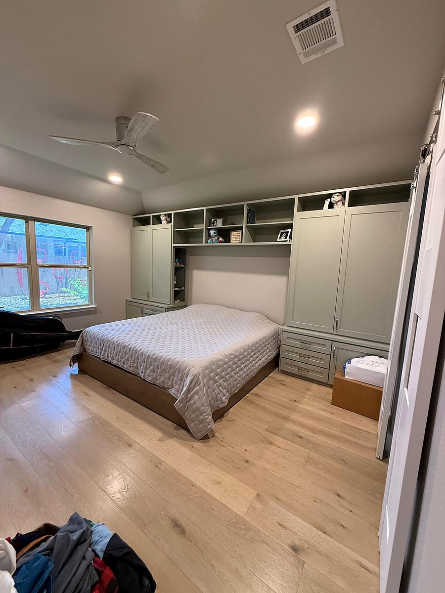 Bedroom with a full wall of built-in wardrobe cabinetry, Austin, TX