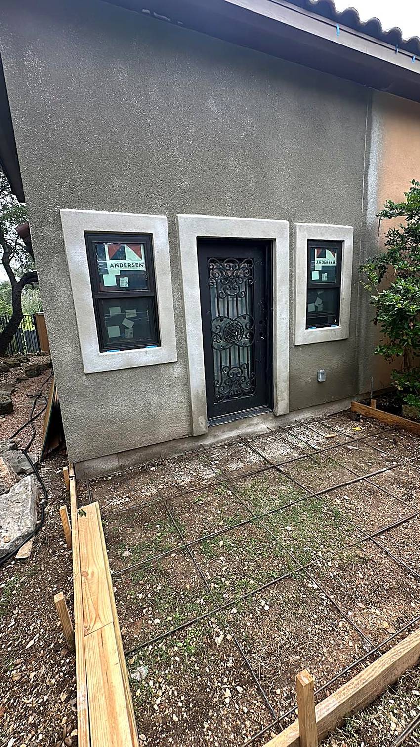 Finished stucco casita with Andersen windows and an iron door, patio slab reinforced and ready to pour, Austin, TX