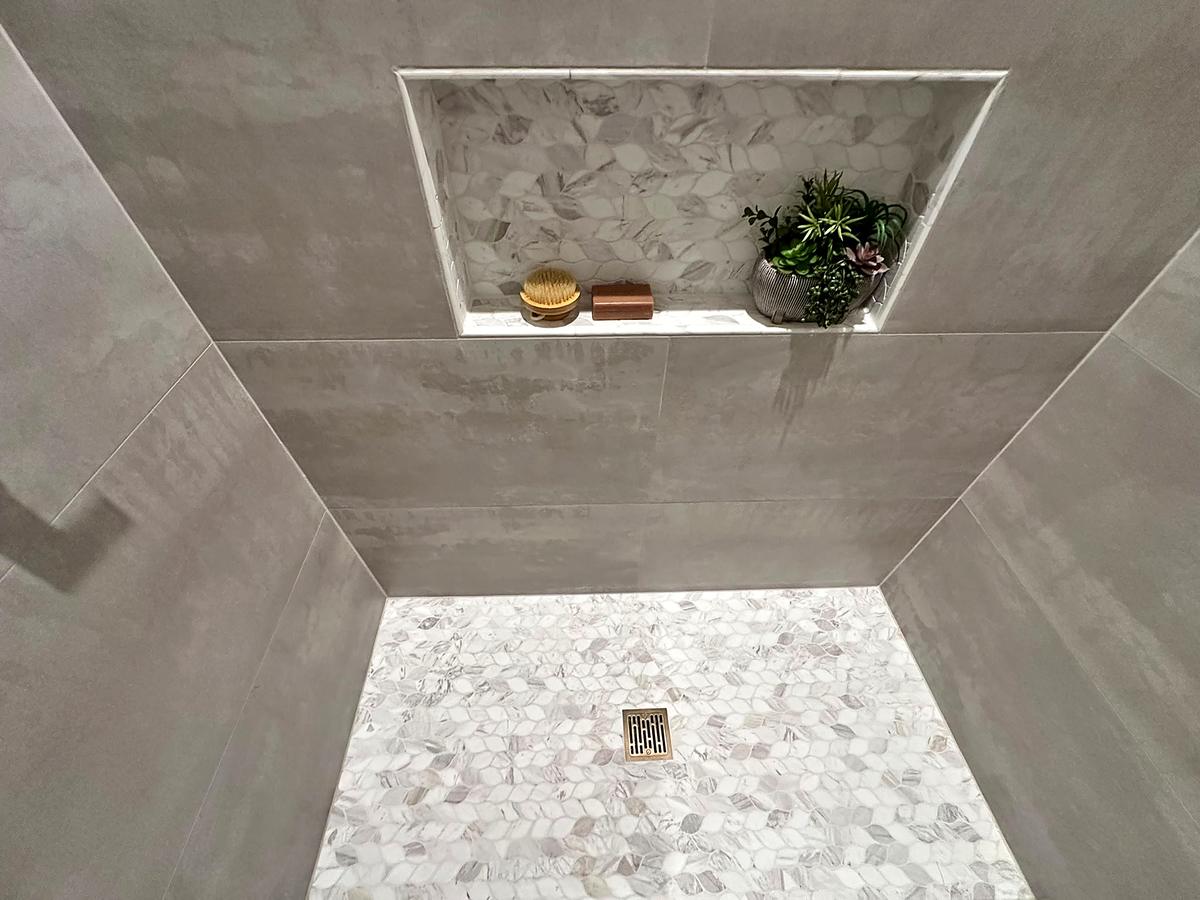 Shower niche and pebble floor seen from below, Austin, TX