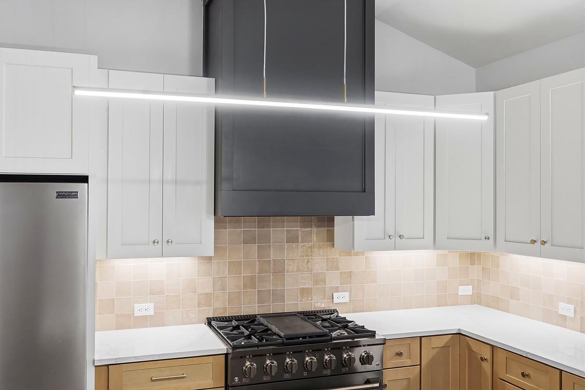 Two-tone kitchen range wall, white uppers over wood lowers, Austin, TX
