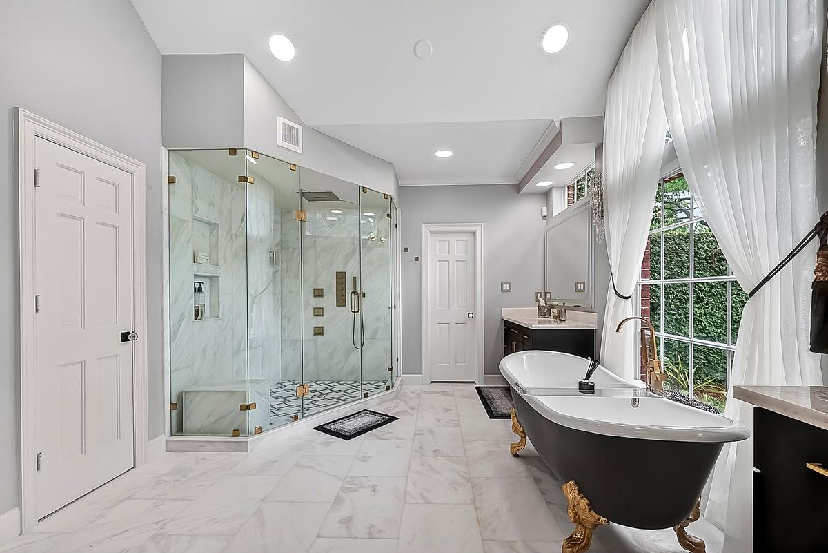 West Lake Hills — clawfoot tub and marble floor in the primary bathroom, Austin, TX