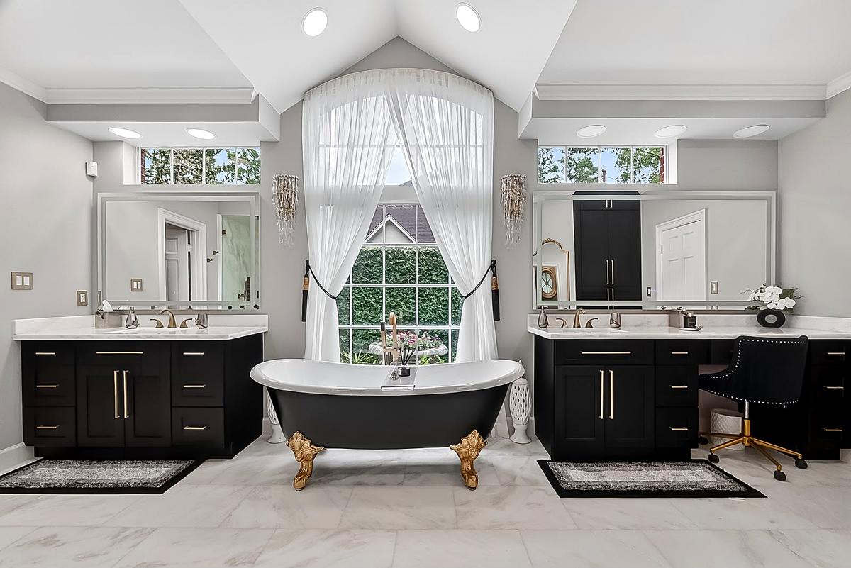 West Lake Hills — clawfoot tub on a marble floor between twin vanities, Austin, TX